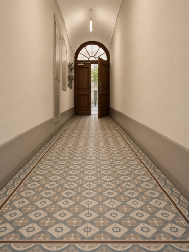 Narrow hallway with patterned geometric tile floor leading to open wooden double doors and an arched transom window above the doorway, beige walls and soft lighting.